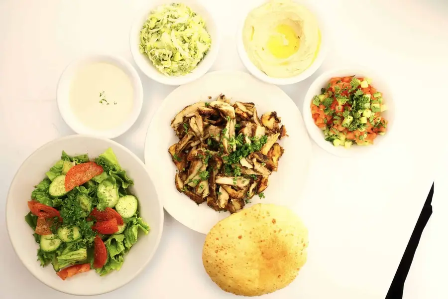 Chicken shawarma plate with hummus, salad, rice and pita